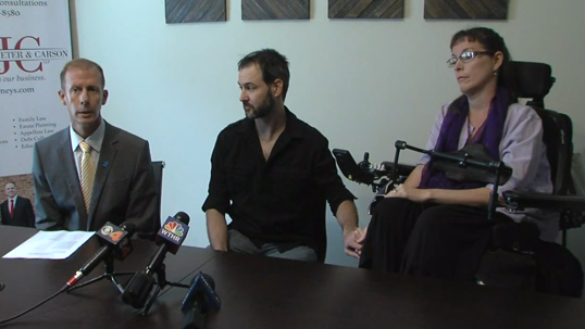Attorney and couple announcing law suit